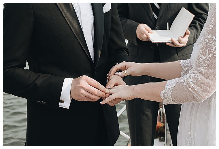 The bride and groom exchange rings on the Tred Avon River to symbolize their commitment to each other