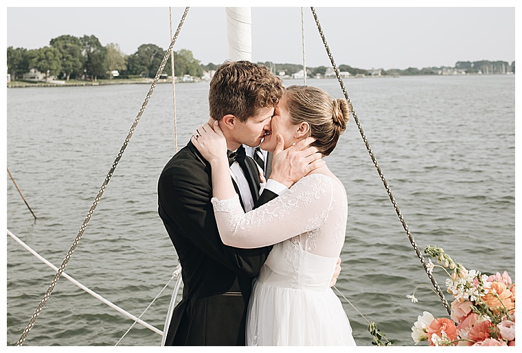 The bride and groom share their first kiss as newlyweds to conclude a romantic waterfront ceremony on the Tred Avon River