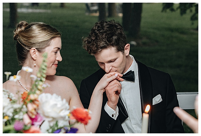 The bride and groom exchange romantic looks of love at their first dinner as newlyweds
