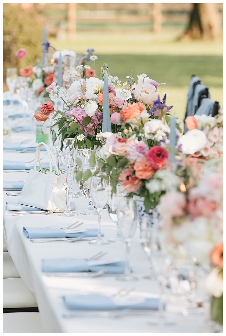 Pastel florals with dusty blue details decorate the table for a gorgeous reception on the Eastern Shore of MD