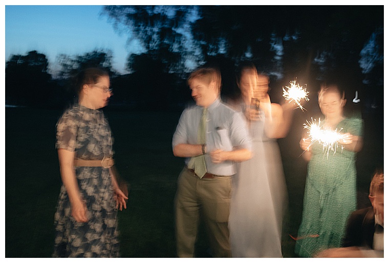 Wedding guests celebrate with sparklers