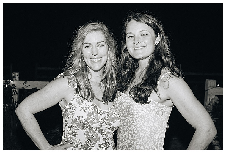 The bride poses for a photo with one of her guests during the reception