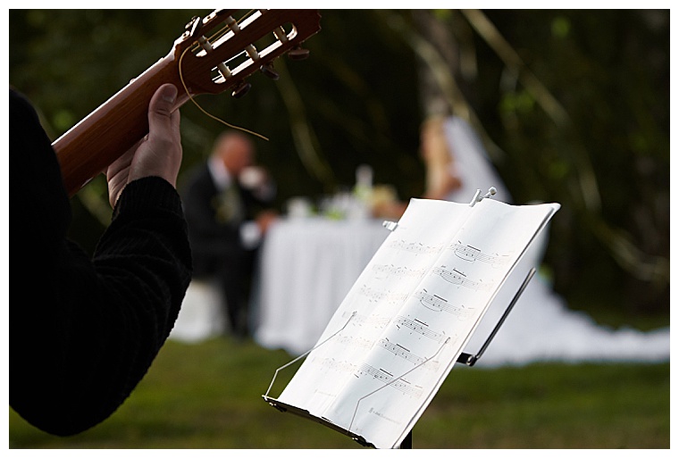 Cropped photo of a musician and a rack with notes against a pair of newlyweds.