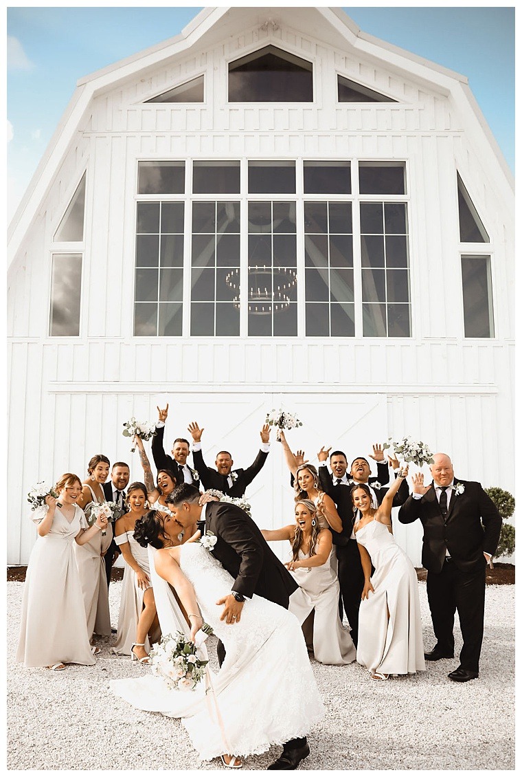 Breckenridge Barn set the perfect stage for celebratory bridal party photos with the bridesmaids and groomsmen cheering on the newlyweds