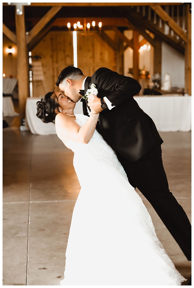 The bride and groom share their first dance as newlyweds and are all smiles as they romance across the dance floor