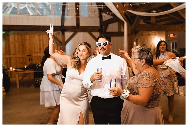 Guests take turns sporting heart shaped sunglasses throughout the reception