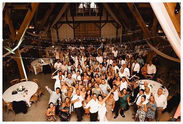 A group photo of the reception taken from the balcony of Breckenridge Barn