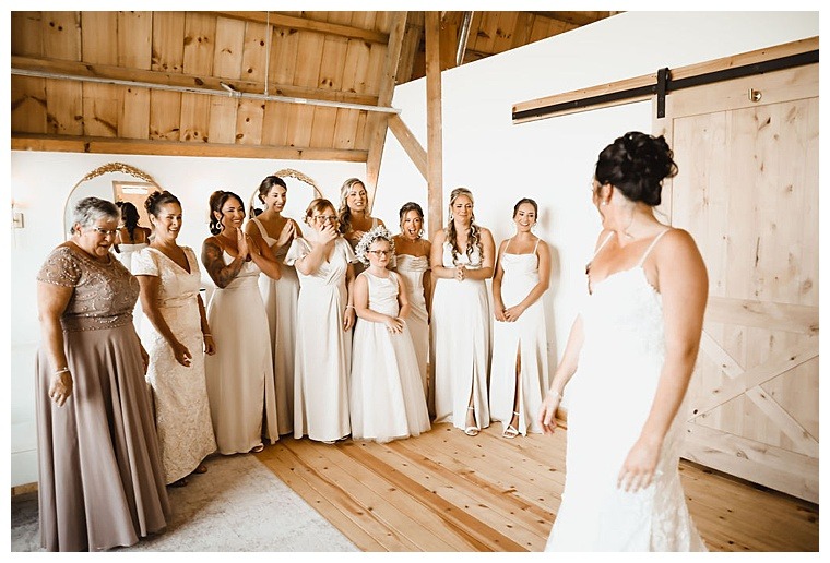 An adorable first look with the bridesmaids so the bride can debut her stunning lace fit and flare mermaid shaped wedding gown