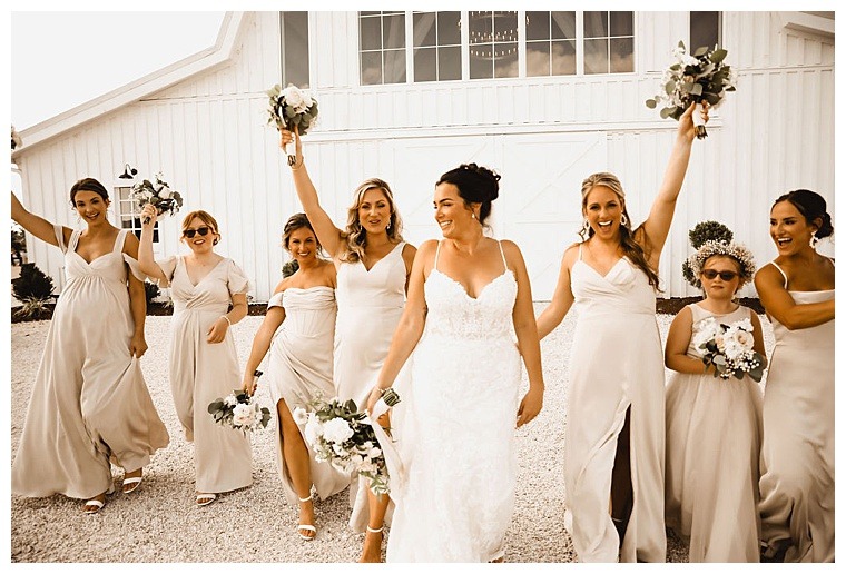 The bride is surrounded by celebration from her bridesmaids at Breckenridge Barn