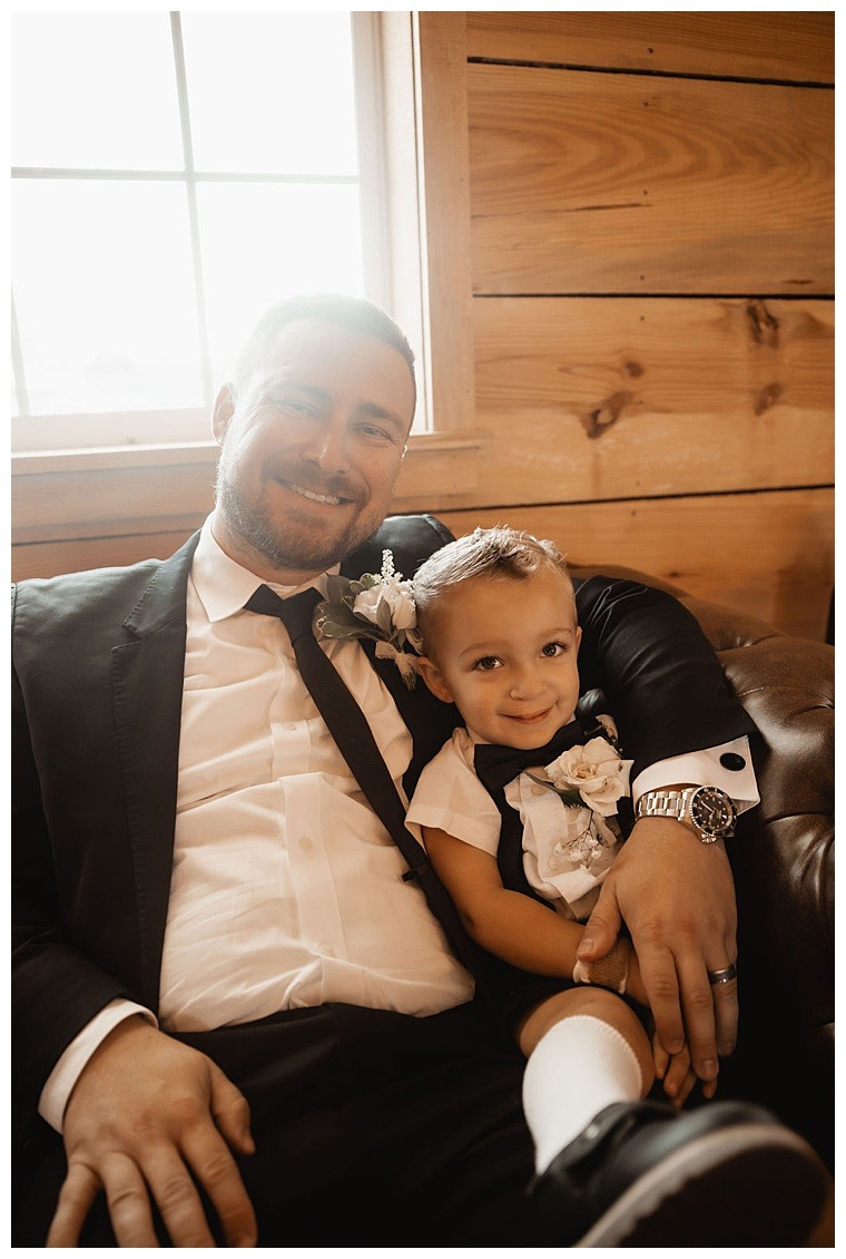 Groomsmen getting ready for the wedding day at Breckenridge Barn with an adorable ring bearer