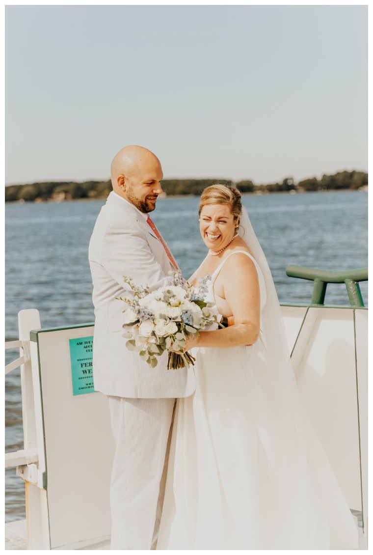 The bride is all smiles as she is embraced by a loving groom during their private first look moment on the Oxford Bellevue Ferry