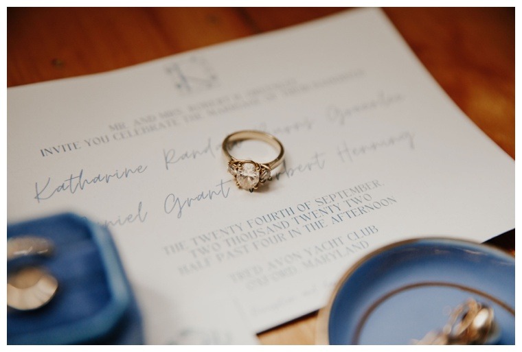 Engagement ring on display with a simply classic invitation suite and blue velvet ring box