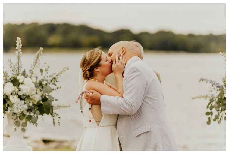 The bride and groom share their first kiss as newlyweds
