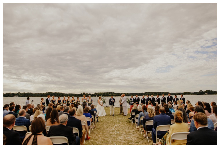 Guests gather for a waterfront exchanging of vows