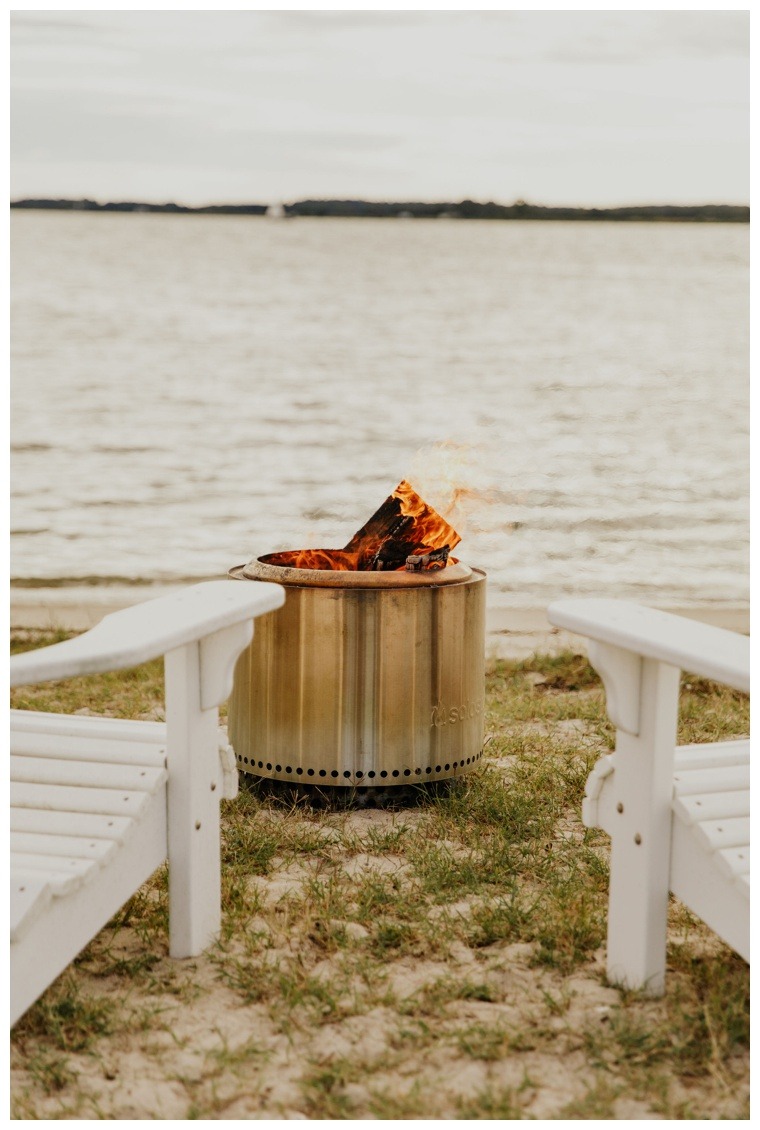 A waterfront fire pit to keep guests warm on a chilly waterfront wedding day