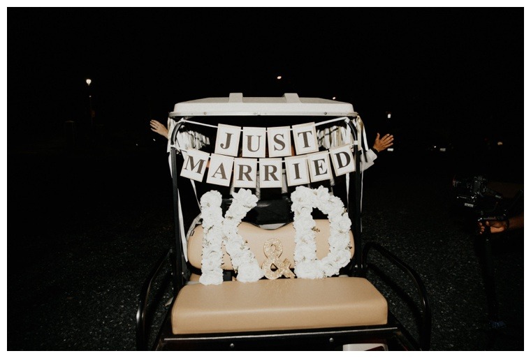 A getaway golf cart complete with a just married sign and the initials of the bride and groom