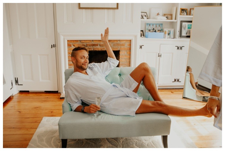 The man of honor adorns his bridesmaid's robe as he helps the girls get ready for the big day | Groomsmaid | Bridesman | Man of Honor | Best Woman