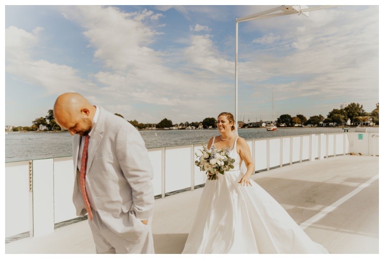 The groom waits patiently on the Oxford Bellevue Ferry for his bride to arrive to share a private first look moment
