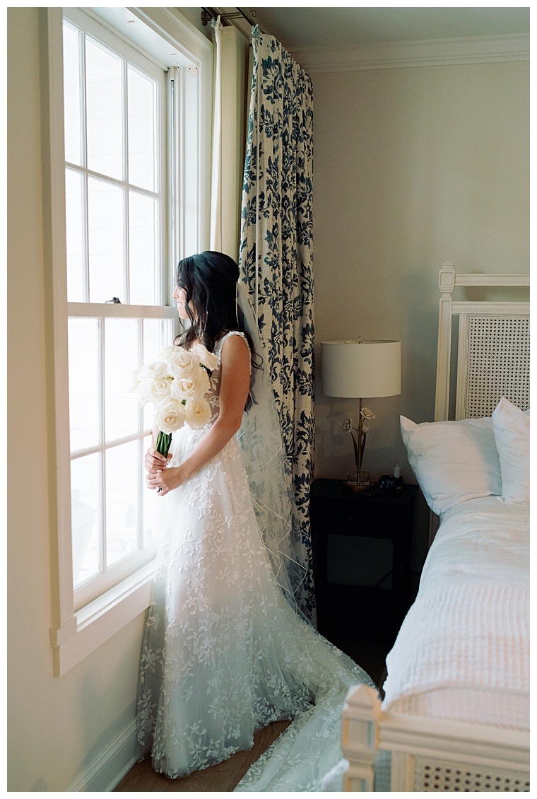 The bride is stunning in an a-line lace gown with a matching cathedral length veil