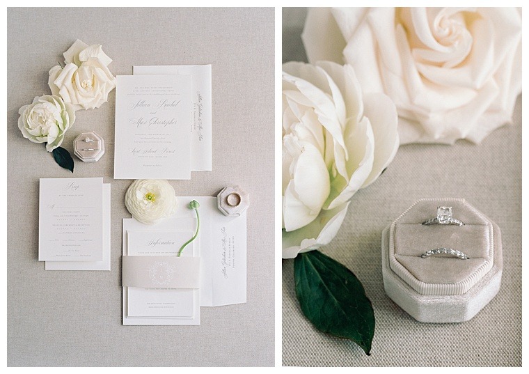 The classic and elegant invitation suite is surrounded by wedding day details of white roses and wedding bands