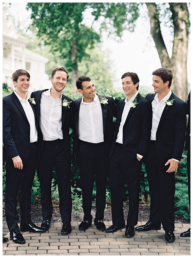 Groom and groomsmen are sporting all black suits for the big day, with chic black patent dress shoes