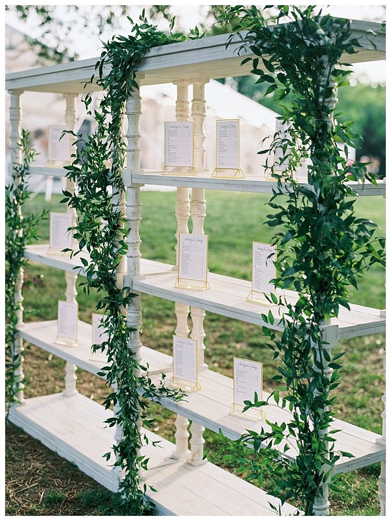 Greenery details the escort cards to show the guests to their table for a beautiful garden reception