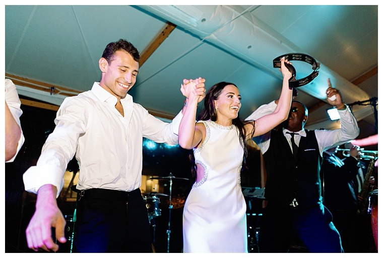 A tambourine in hand, the bride leads the dance floor in celebratory dance moves