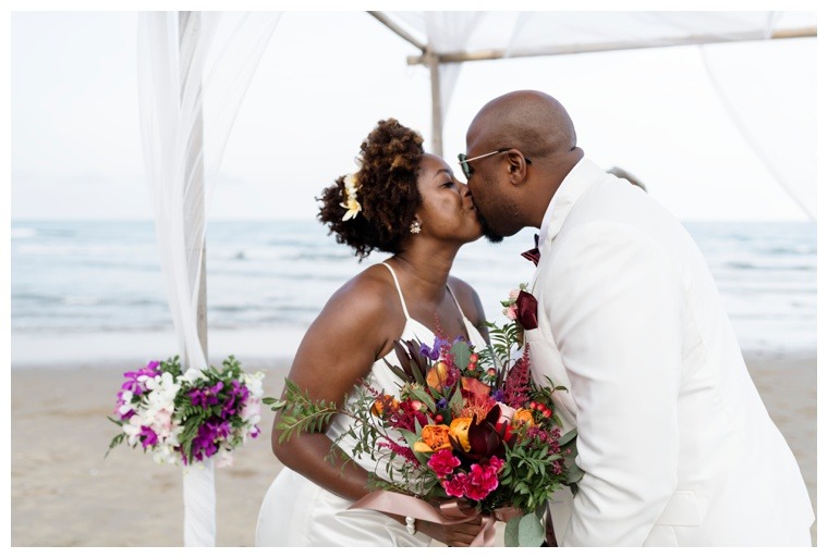 The bride and groom share their first kiss as husband and wife to conclude their beach wedding ceremony on the eastern shores of maryland beaches