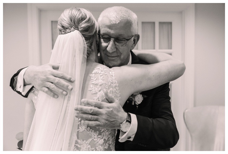 Bride and grandfather hug on her wedding day