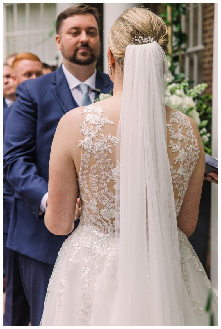 The couple exchanges vows at the Tidewater Inn | Cathedral Veil | Wedding Hair