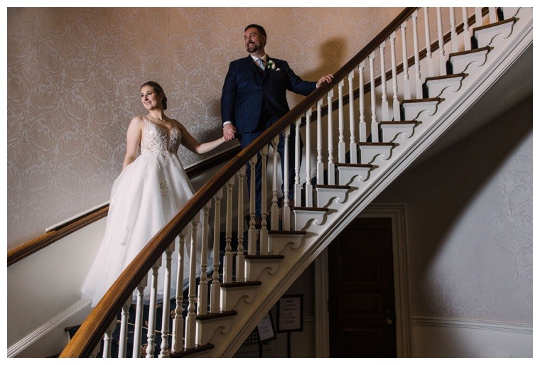 Bridal portrait photography by Laura's Focus Photography on a stunning spiral staircase at the Tidewater Inn