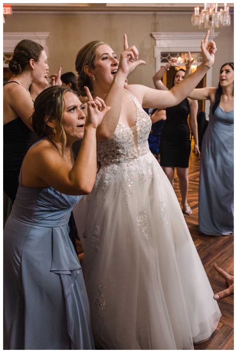 Bride and bridesmaids celebrate on the dance floor at the Tidewater Inn