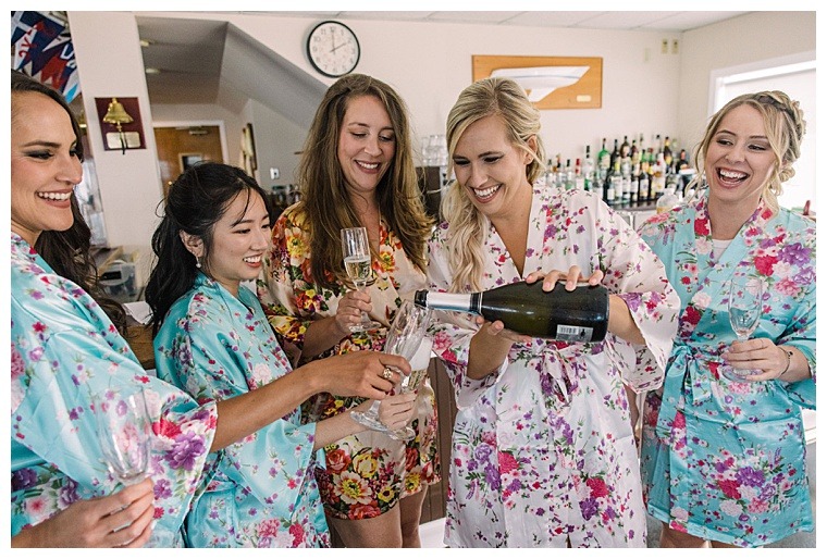 The bridesmaids toast to their bride as they get ready for the ceremony
