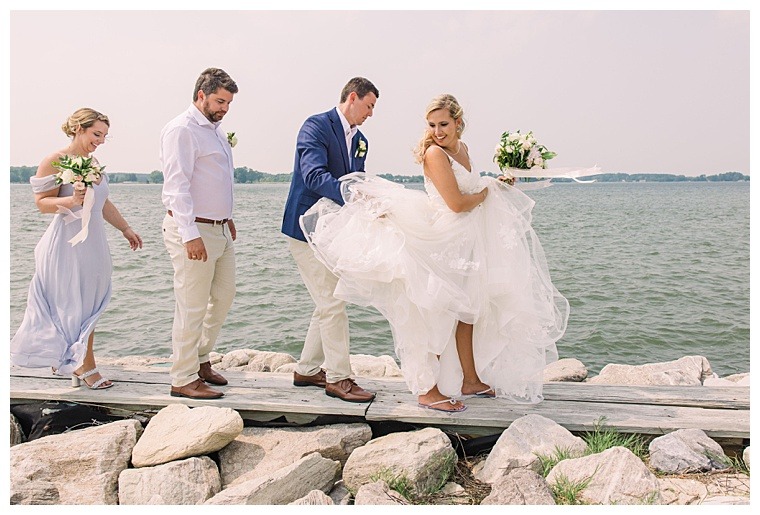 The bridal party walks along the waterfront in Oxford MD enjoying the wedding day views
