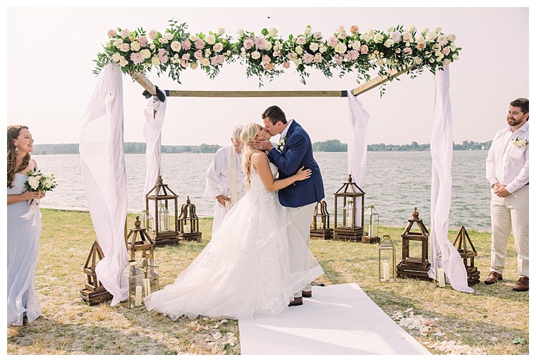 A stunning ceremony site is decorated with florals by Seaberry Farm for this waterfront Oxford wedding