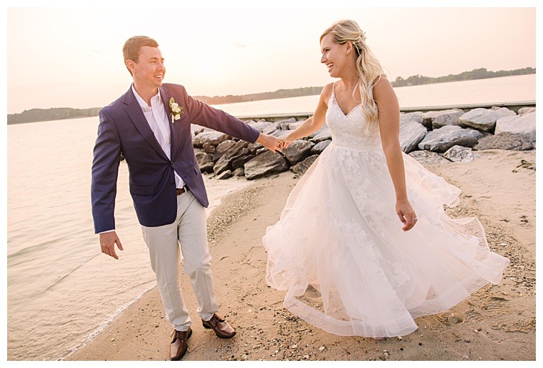 The bride and groom dance on the beach in the sunset on the shores of the Tred Avon River at their Oxford MD wedding reception