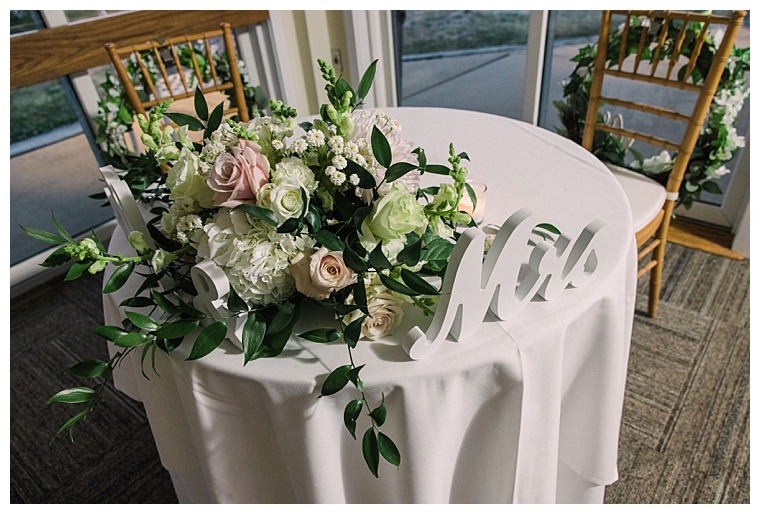 Florals by Seaberry Farm decorate the sweethearts table for their first dinner as husband and wife