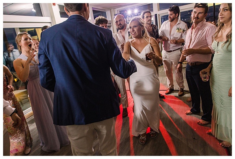 The bride meets her new husband on the dance floor surrounded by friends and family at the Tred Avon Yacht Club