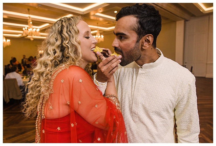 The bride and groom share their first dessert as husband and wife
