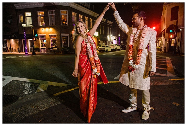 The bride and groom celebrate under the street lights of downtown Easton
