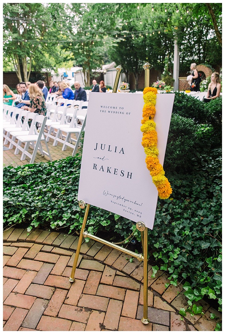 A custom wedding sign for Julia & Rakesh with yellow florals