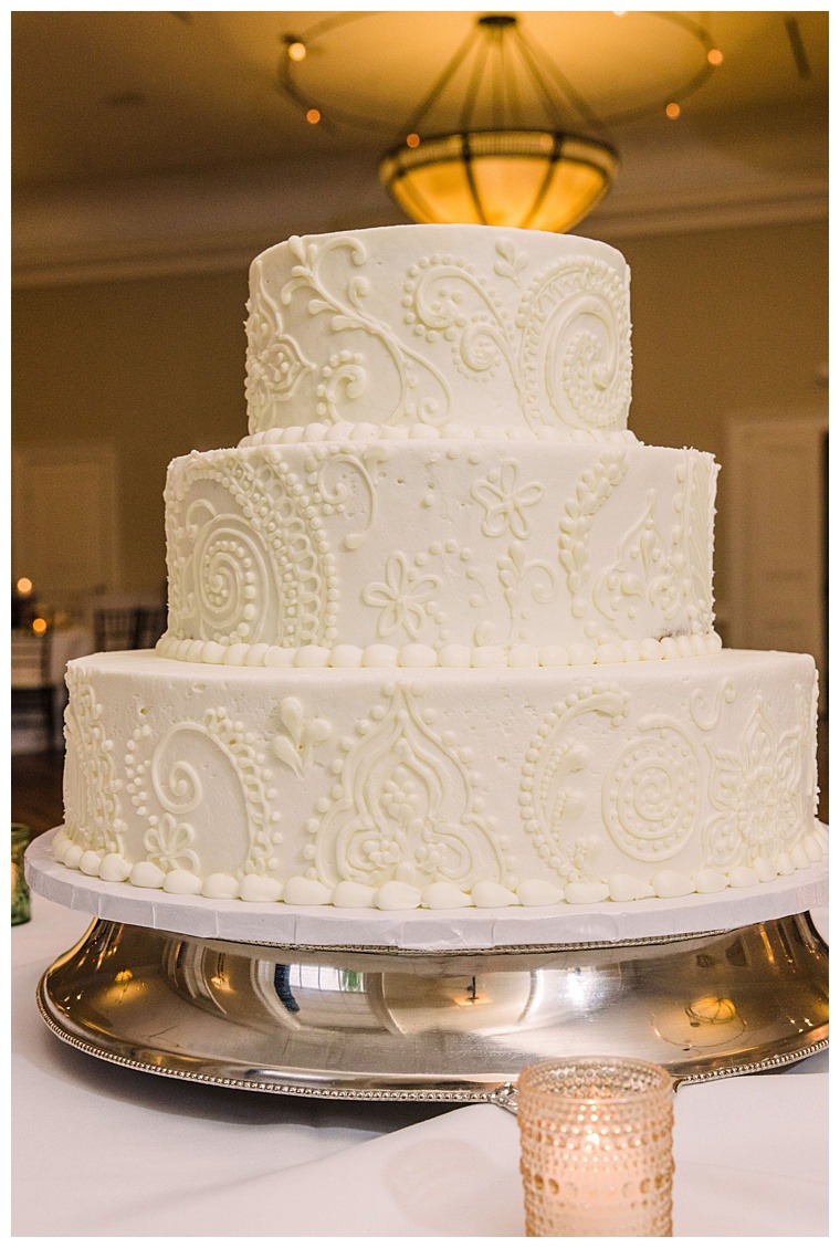 A stunning, 3 tiered wedding cake, with intricate henna designs celebrating the rich indian culture of this wedding