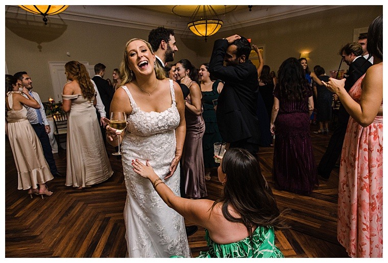 The bride is all smiles on the dance floor with her guests at the Tidewater Inn