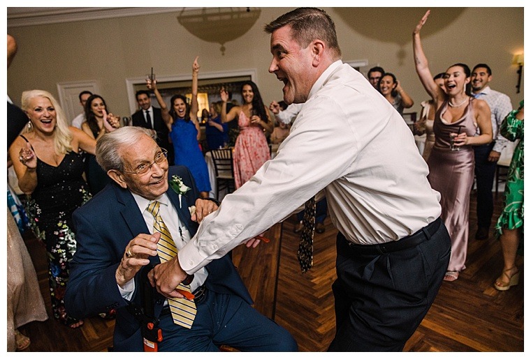 Wedding guests dance in the golden ballroom at the Tidewater Inn