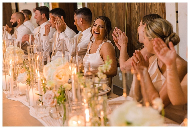 The bridal party is all smiles during the celebratory toasts to kick off a splendid reception full of laughter and dancing | Barn Wedding Reception | Laura's Focus Photography