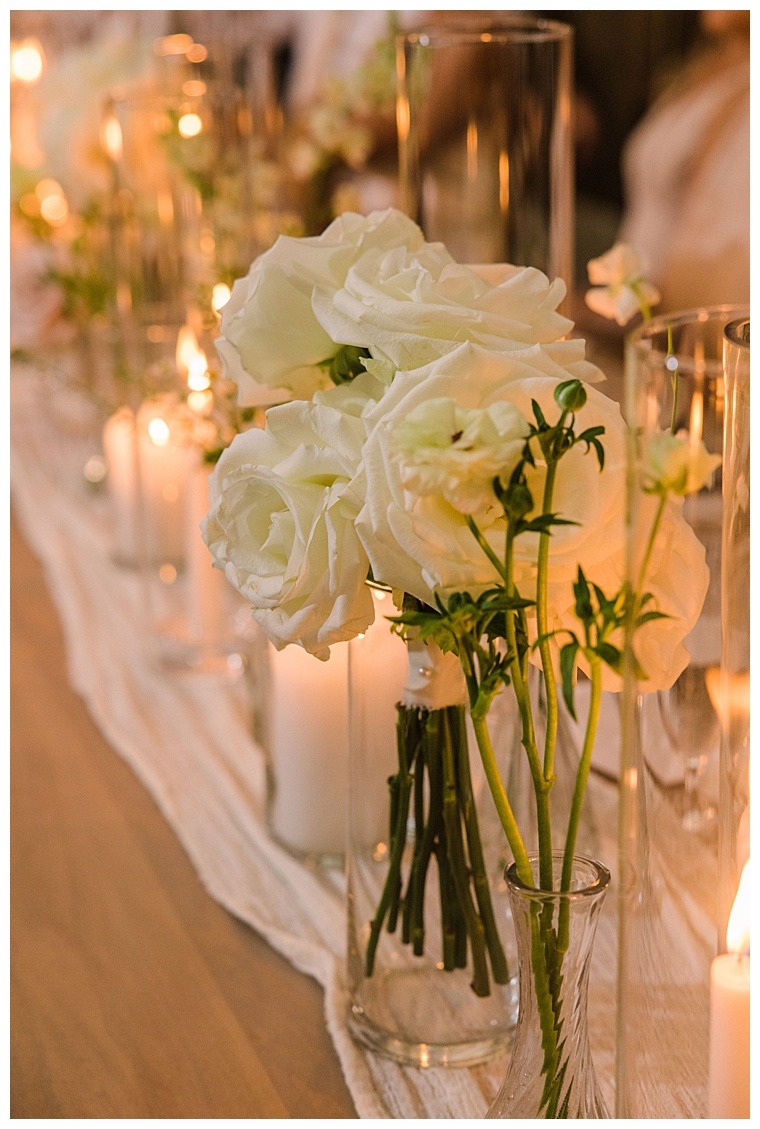 White roses detail the entire reception site creating an ambience of elegance